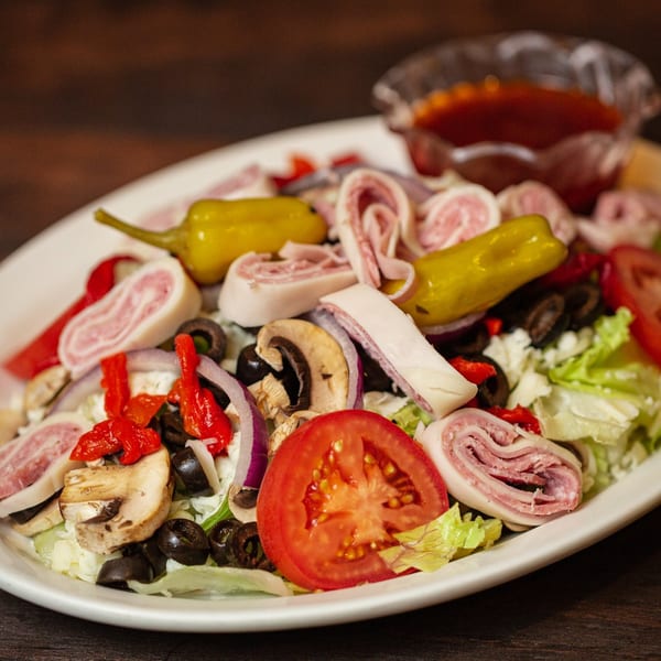 Primo Brothers Pizza's antipasto salad with meats, cheeses, olives, peppers, tomatoes, and mushrooms.